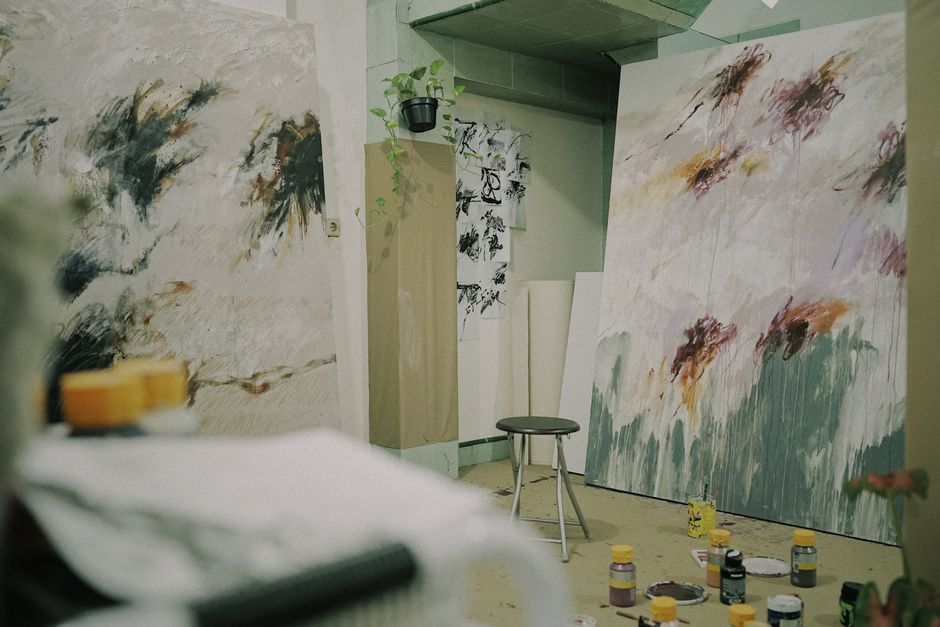 Cozy art studio with expressive abstract paintings and creativity in progress.